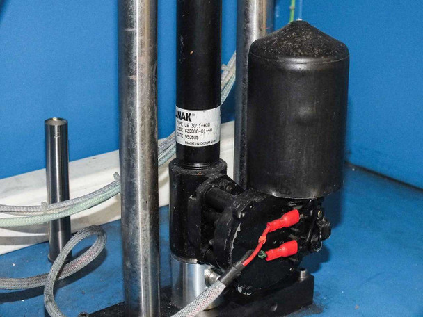 Close-up of Funak peristaltic/diaphragm pump and associated gas line plumbing inside lower cabinet