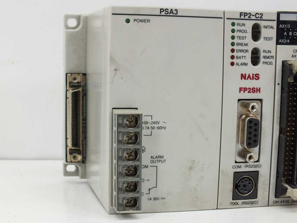 NAIS PSA3 power unit and FP2-C2 CPU (FP2SH) closeup — showing POWER LED, 100-240V AC rating label, alarm output terminals, and RS-232C TOOL and COM ports