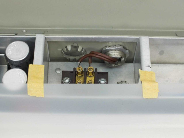 Interior closeup of LCD Co MF-7A showing terminal block, strain relief fitting, and wiring connections in right electronics compartment