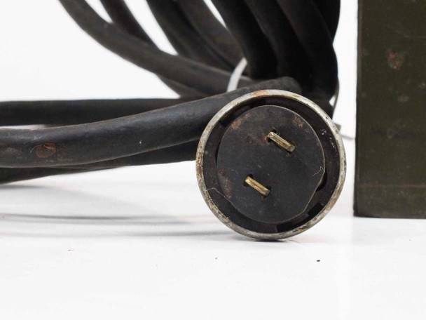 Close-up of multi-pin circular power plug on MIL-V-10537 Voltage Control Unit, showing two blade contacts and round collar