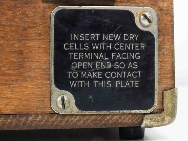 Close-up of battery compartment instruction plate on Winslow Co Type 301 case side — reads 'Insert new dry cells with center terminal facing open end'