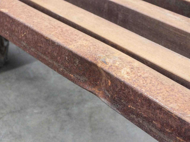 Close-up of bent horizontal support bar on Cost Cutter cart frame rail showing outward bow deformation and heavy rust