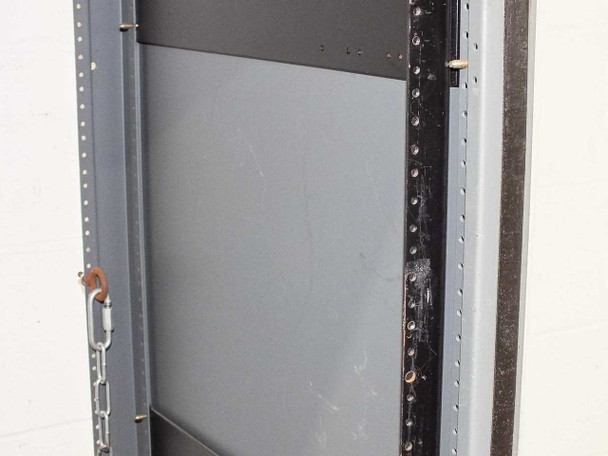 Side interior view of rackmount cabinet showing square-hole rack rail column, side panel, and chain latch hardware