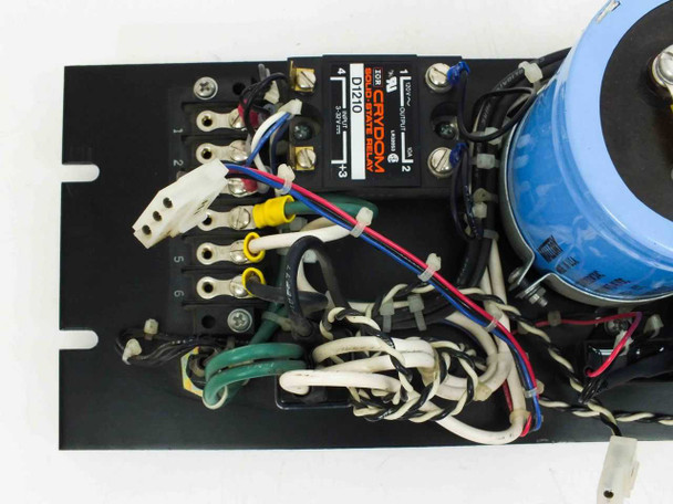 Crydom D1210 solid state relay close-up on rack panel – numbered terminal block with six terminals and multi-color wiring, partial capacitor visible