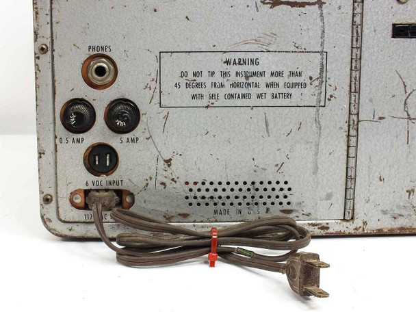 Simpson 498-A — close-up of rear panel showing Phones jack, 0.5 Amp and 5 Amp fuse holders, 6 VDC input, ventilation grille, warning label ('Do not tip more than 45 degrees from horizontal when equipped with self-contained wet battery'), and AC power cord