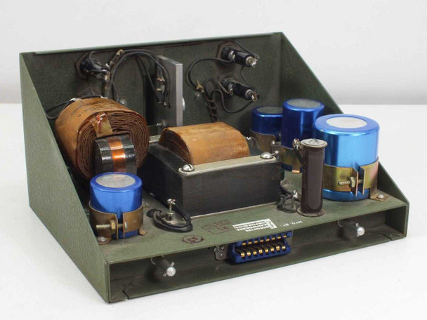 PTC 10190-A interior — top-down angled view showing two wound transformer cores, large blue electrolytic filter capacitors, inductor, wiring harness, and rear multi-pin connector
