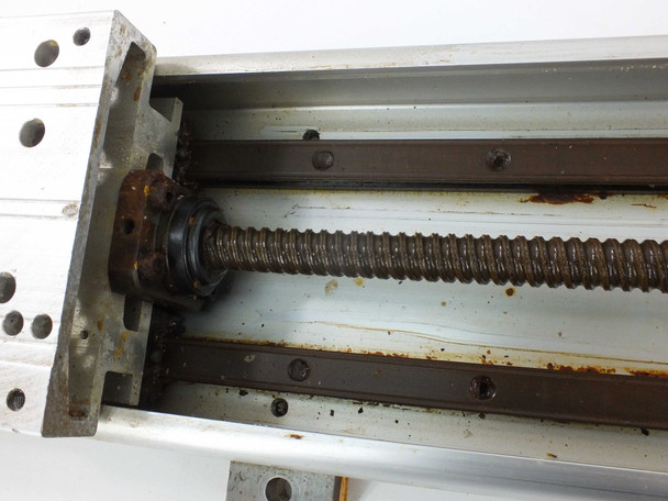 Yamaha LS1BL-850 end detail showing ball screw nut, bearing block, and screw threads with rust and surface corrosion