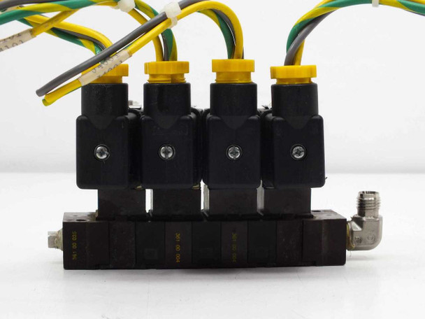 ASCO 10900001 solenoid valve manifold front view showing four yellow-capped coil bodies mounted on manifold block