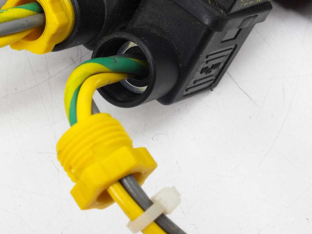 Close-up of yellow push-to-connect pneumatic fitting and wiring harness connector on ASCO solenoid valve coil
