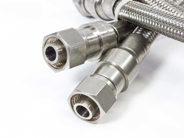 Close-up of Swagelok 1/4-inch compression tube fitting ends on SS FM Series braided flex hose — both hose ends shown side by side