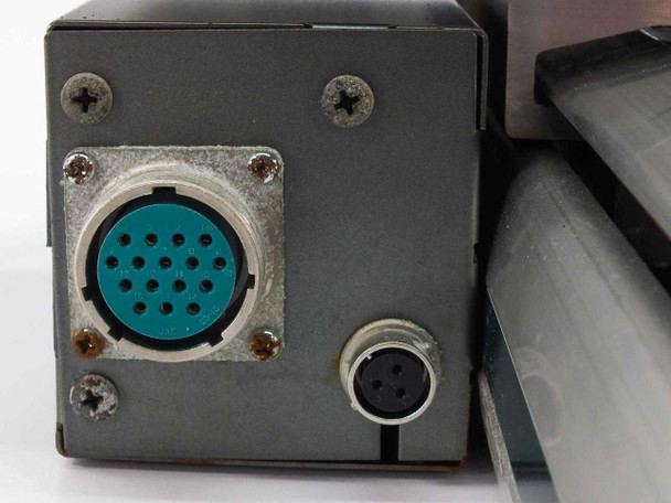 End plate of Yamaha linear slide carriage showing 19-pin circular connector (teal insert) and small M12 circular connector on black bracket