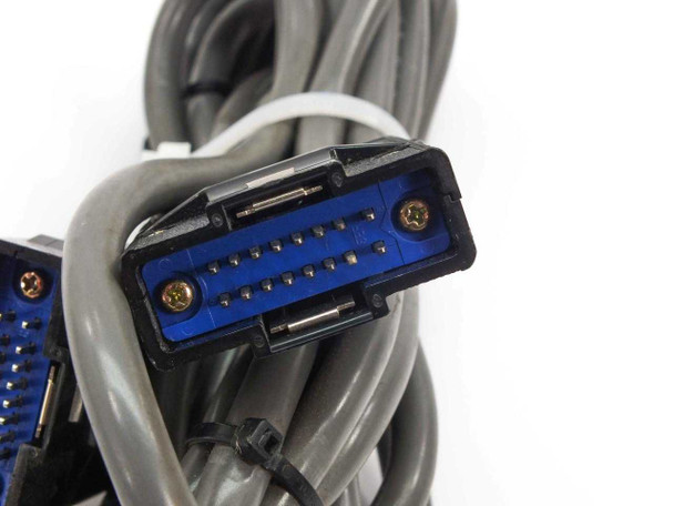 Close-up of blue D-sub style multi-pin connector end on interconnect cable — pin detail visible