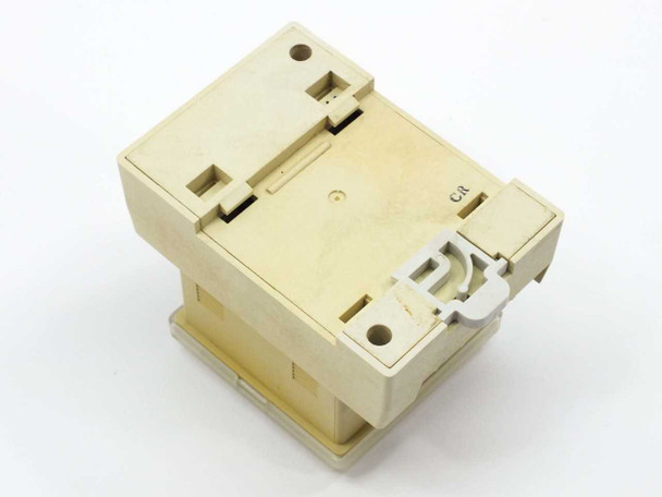 SMC PSE100-B pressure switch rear and bottom view showing DIN rail clip and plastic housing — cream colored enclosure