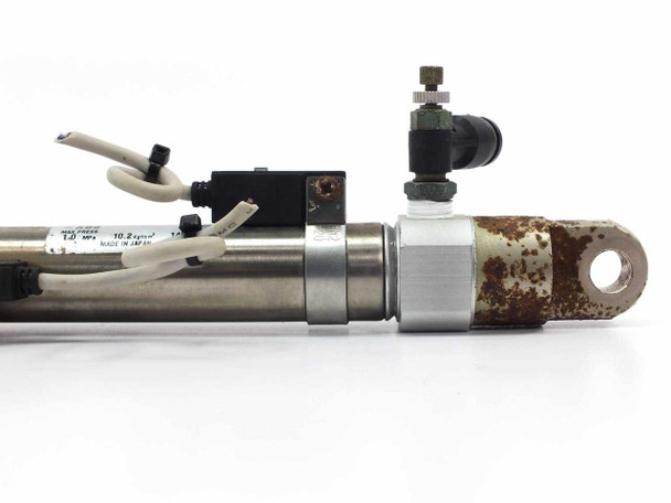 SMC CDM2C20-80 cylinder – rear clevis end closeup showing surface rust on cylinder body and push-in fitting with auto-switch