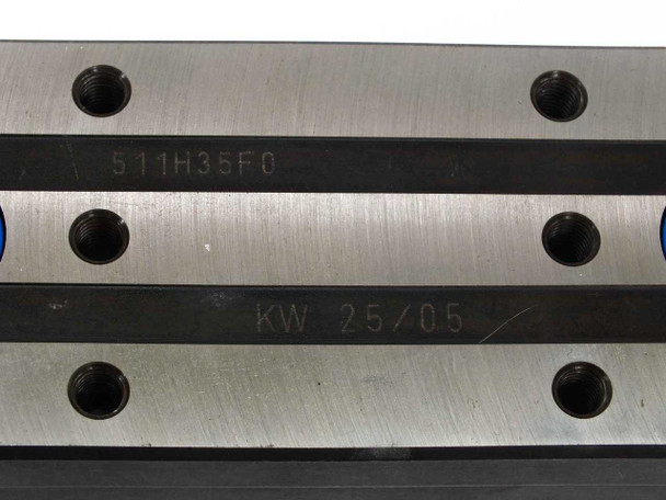 Thomson 511H35F0 carriage top surface showing model number stamping and KW 25/05 date code with mounting hole pattern