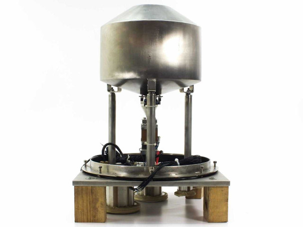 DSM vibratory hopper feeder rear view showing stainless dome hopper, column supports, base platform, and wiring