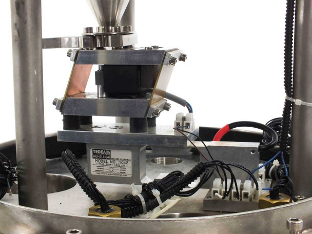Close-up of Tedea Huntleigh 1042 load cell mounted under hopper platform with wiring harness and coiled cables