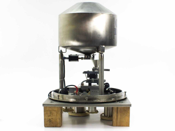 DSM vibratory hopper feeder front view showing stainless steel dome hopper, support columns, vibrating platform, and wooden base