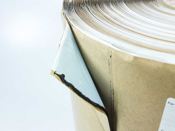 Schnee-Morehead 51959012 butyl tape — corner detail with kraft paper liner peeled back revealing black butyl adhesive layer