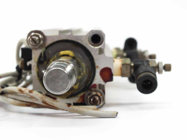 SMC pneumatic cylinder rod end closeup – showing threaded piston rod, mounting hardware, and surface rust on end cap and fasteners