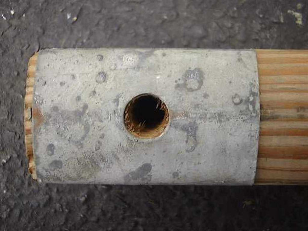 Metal end cap with center hole on US Tucker Ridge military tent pole — cap detail close-up