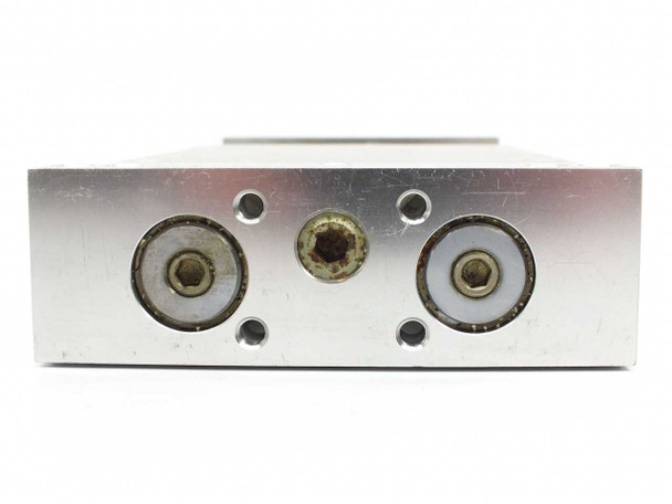 SMC CDPXWL32-75-J79L opposite end cap showing two cylinder rod ports and central threaded port with light surface oxidation