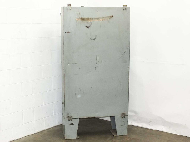 Hammond 1418 T12 enclosure rear view showing rust streak across top, surface scratches and pitting, connection holes at top, and floor legs