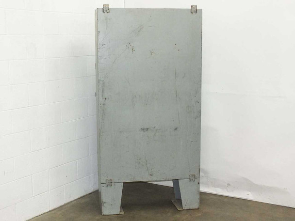 Hammond 1418 T12 enclosure rear exterior – back panel showing painted steel with surface scuffs and scratches, conduit knockouts at top, integral leg base