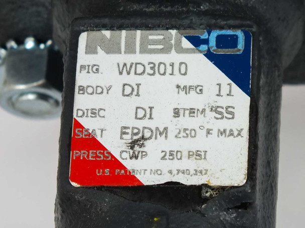 Nibco WD3010 label close-up showing Fig. WD3010, Body DI, Disc DI, Stem SS, Seat EPDM 250°F Max, Press. CWP 250 PSI, and U.S. Patent No. 4,940,397
