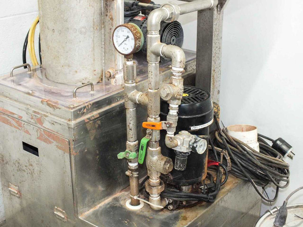Side view of effluent treatment system piping, pressure gauge, Ulvac DTP-45D vacuum pump, and valve assembly
