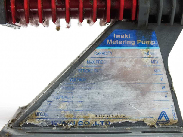 Iwaki EH-C20SH-200R9 metering pump rating plate label on base showing Iwaki Metering Pump markings and MFG number M020-1016