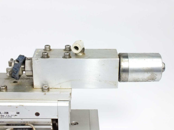 SMC MXS20L-20B — front end view showing white pneumatic port fitting, mounting bolts, and cylinder body