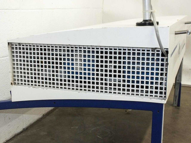 End-panel view of laminar flow hood showing square-grid intake/exhaust grille on the short face of the white enclosure, blue stand leg visible