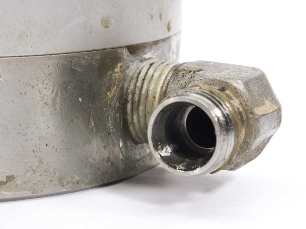 Sawatec SP-177 dosing pump – close-up of fluid outlet port showing threaded compression fitting with dirt and residue buildup on stainless body