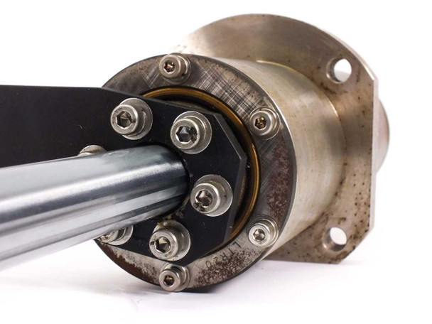 Close-up of 100mm mounting flange face with four 9mm bolt holes, dual output shafts, and socket-head cap screws securing the end cap