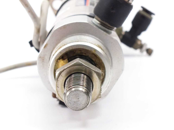 SMC CDM2G32-65-H7BL3 – rod end closeup showing threaded rod, hex nut, and push-in fitting with visible grease/wear at rod seal
