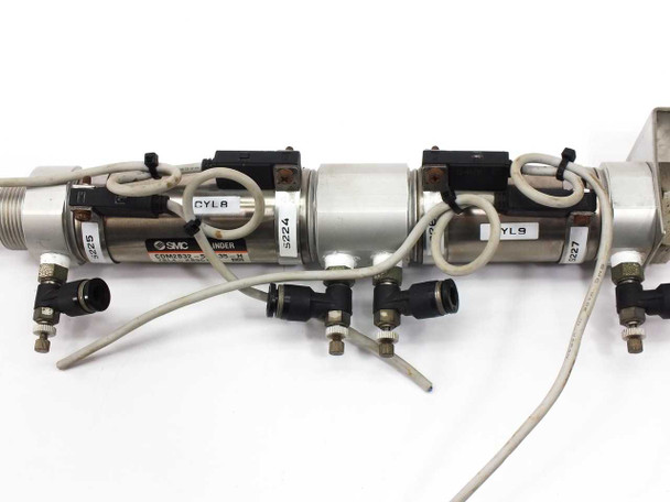 SMC CDM2B32-55 CM2 cylinder assembly — top view showing two cylinder bodies, auto-switch mounts, pneumatic tubing, and labeled CYL A and CYL 9 markings