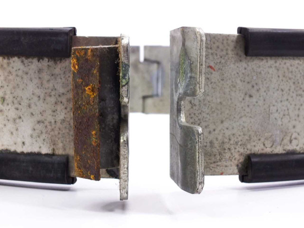 Cherry-Burrell bracket clamp – close-up of latch/clasp hardware showing heavy rust, corrosion, and cracking rubber edges