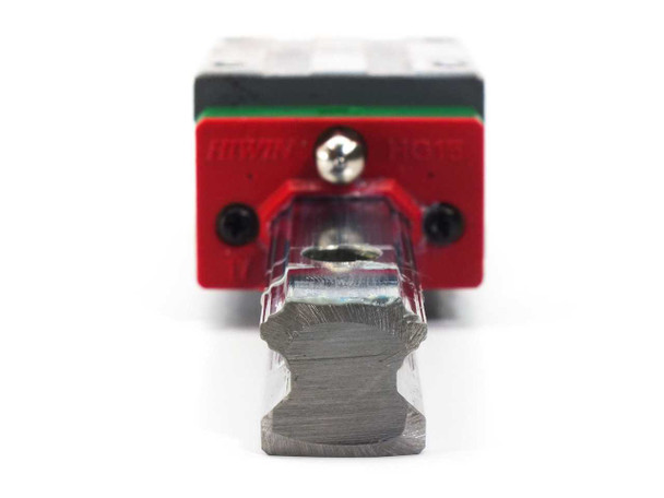 Hiwin HGH15CAH carriage block — close-up end view showing red end seal, lubrication fitting, and machined rail cross-section profile
