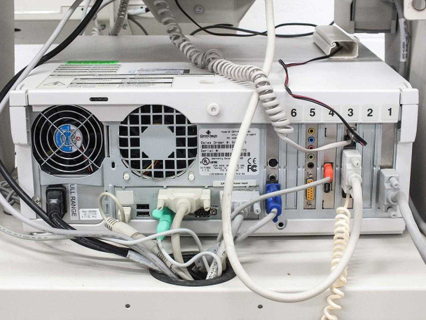 Omnitech CPU rear panel showing dual cooling fans, power supply, and multiple I/O connections with cables attached