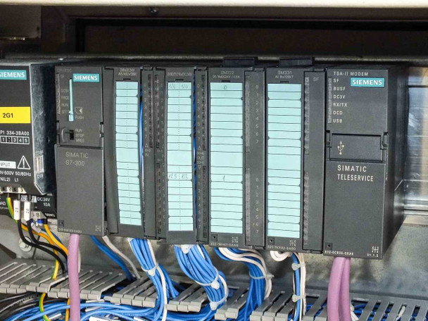 Siemens Simatic S7-300 PLC module rack closeup – CPU 315-2A00, multiple SM321/SM322 digital I/O modules, TSA-II modem module, and Simatic Teleservice module