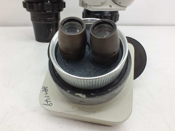 Close-up of Parco EMZ microscope head base showing binocular eyepiece tubes and zoom knob ring