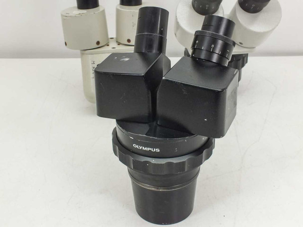 Olympus VMZ zoom head close-up showing front body with Olympus brand ring and zoom adjustment collar