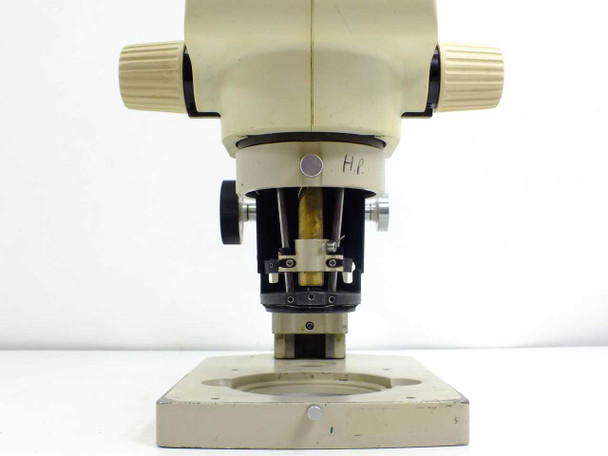 Front view of Leica GZ6 focus block and objective port showing 50mm objective opening, focus mechanism hardware, and asset/property marking on head