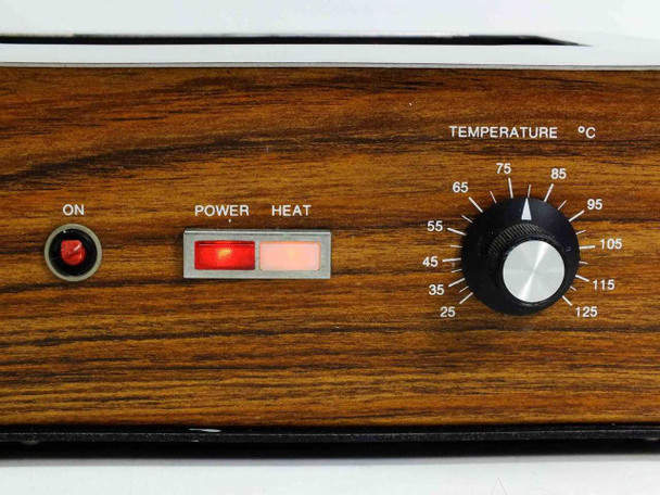 Close-up of Fisher Isotemp 145 front controls showing damaged ON button, lit Power and Heat indicators, and temperature dial with 25–125°C scale