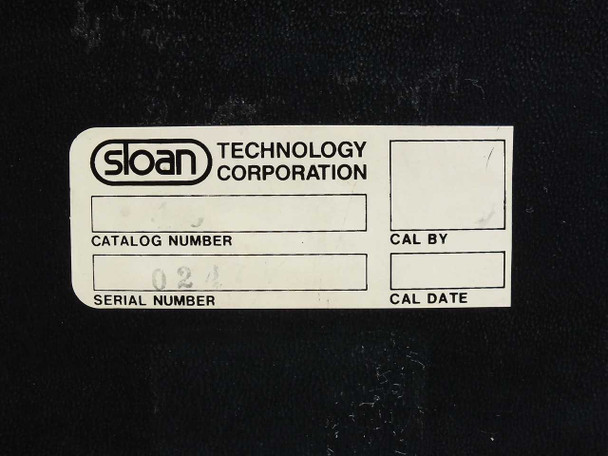 Sloan Technology Corporation calibration label — close-up showing catalog number field, serial number (02..., partially legible), CAL BY and CAL DATE fields blank