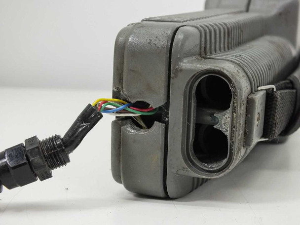 Bottom of YSI 85 meter showing multi-pin cable connector with exposed colored wires at junction