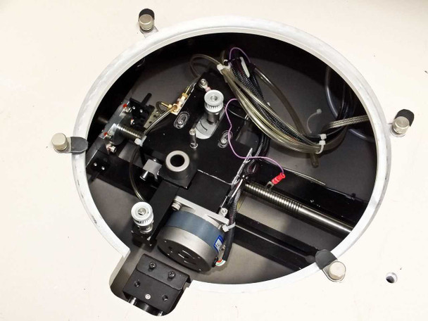 Close-up interior view of PWS P5NMS circular wafer chuck mechanism showing vacuum plumbing, wiring, and X-Y stage components