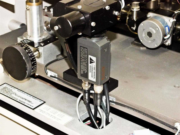 Close-up of sensor module mounted on PWS P5NMS probe arm, black rectangular unit with multi-conductor cable