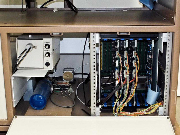 PWS P5NMS lower cabinet interior showing control electronics rack with multiple populated card slots, power supply, and wiring harnesses